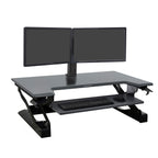 Black adjustable standing desk with dual monitor stand and keyboard tray on a white background