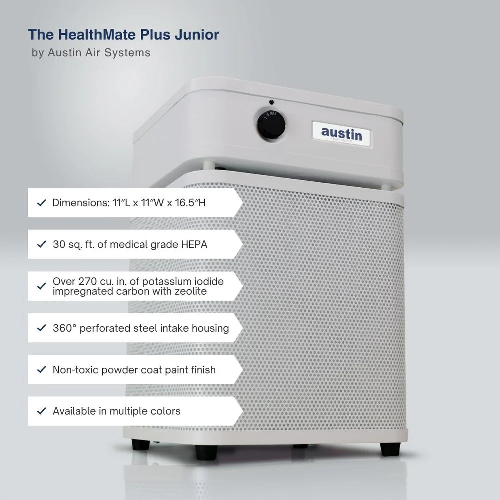 Austin Air Systems HealthMate Plus Junior air purifier shown on a light gray background with feature callout text overlays detailing dimensions, HEPA rating, carbon/zeolite capacity, intake housing, finish, and color availability.