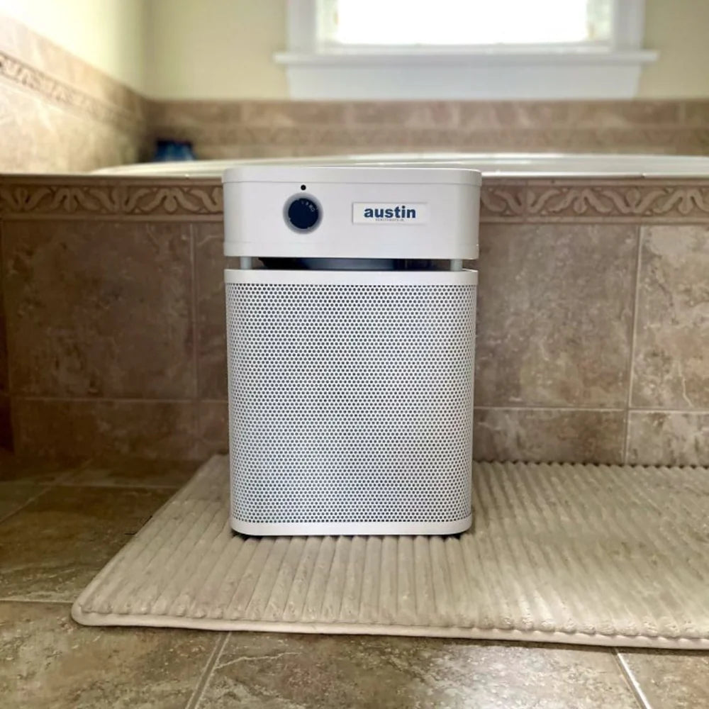 Air purifier with 'austin' branding on a tiled floor.