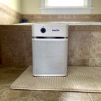 Air purifier with 'austin' branding on a tiled floor.